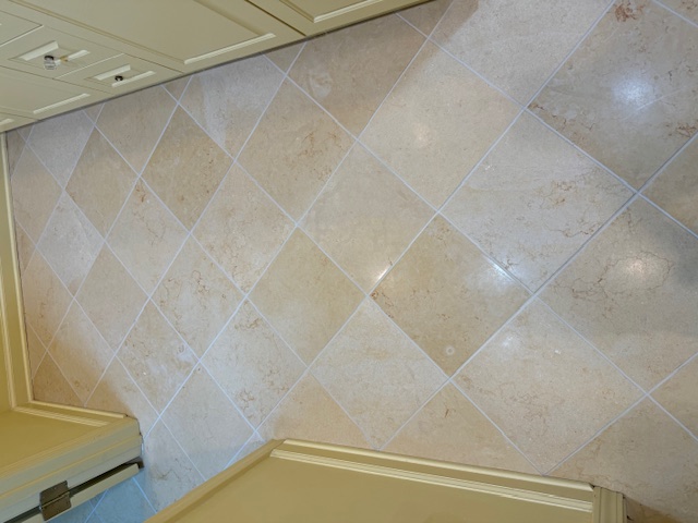 Natural stone floor after professional restoration and grout renewal