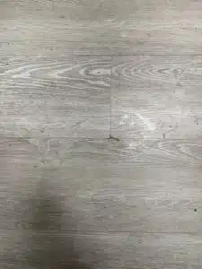 Adhesive buildup on LVT floor before cleaning in Collierville TN